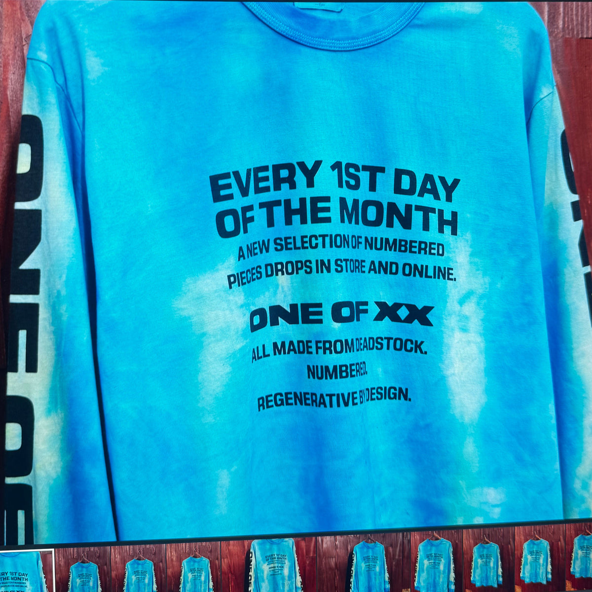 A blue tie-dye graphic sweatshirt displayed on a computer monitor, with the text 'EVERY 1ST DAY OF THE MONTH' printed on the front.